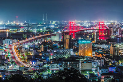 High angle view of illuminated buildings in city at night