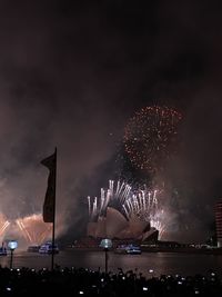 Low angle view of firework display at night