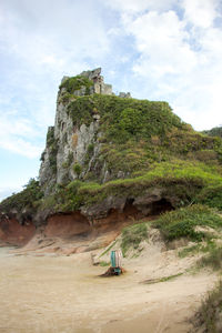 Rock formation on cliff against sky