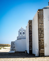 Low angle view of church buildings against clear blue sky