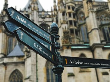 Low angle view of street name sign against building in city