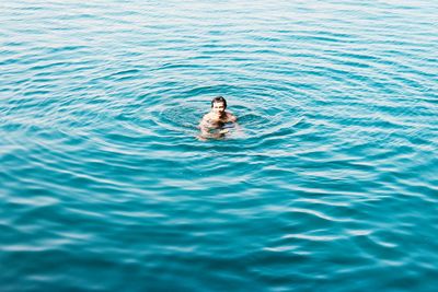 High angle view of man swimming in sea