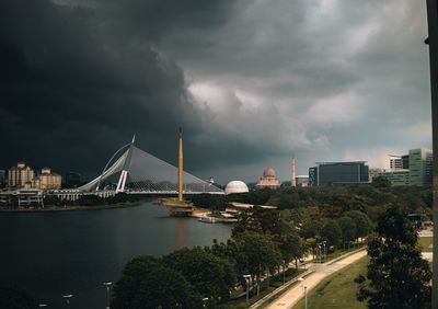 View of bridge over city against cloudy sky