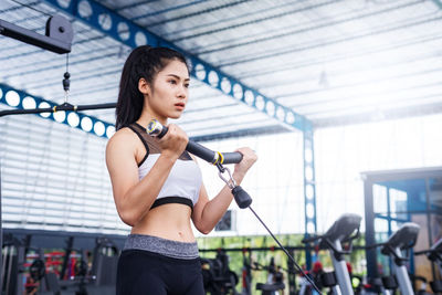 Young woman exercising in gym