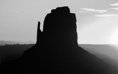 Silhouette of statue against mountain