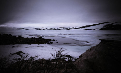 Scenic view of sea against sky during winter