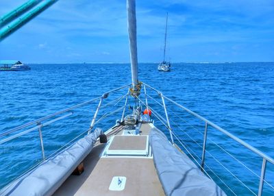 Boats sailing in sea against sky