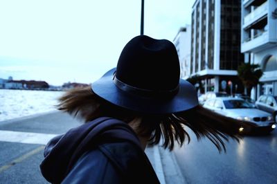 Rear view of woman wearing hat in city