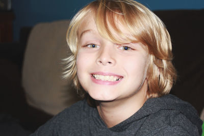 Close-up of boy smiling at home