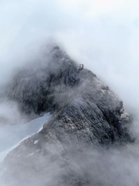 Scenic view of mountain amidst clouds