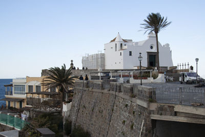 Buildings in town against clear sky