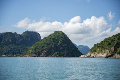 Scenic view of sea and mountains against sky