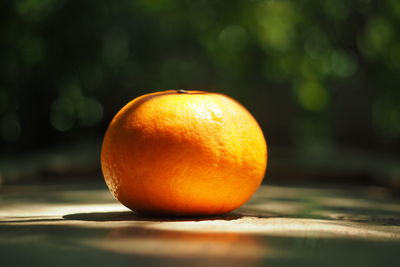 Close-up of orange apple on table