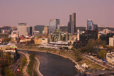 High angle view of river amidst buildings in city against sky