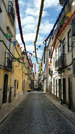 Street amidst buildings against sky