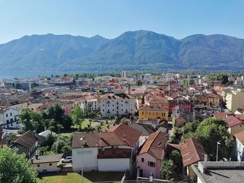 High angle view of townscape and mountains against sky