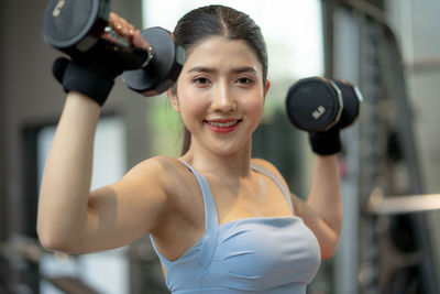 Young woman exercising in gym