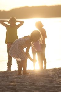 View of people at beach during sunset