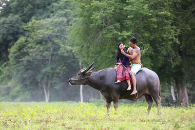 Young woman riding horse