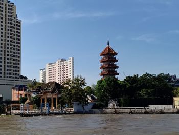 Gazebo by building against sky in city