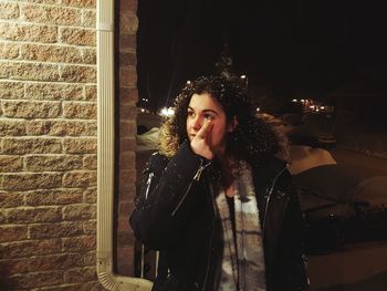 Young woman fur coat outdoors at night during winter