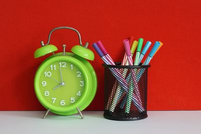 Close-up of multi colored alarm clock on table