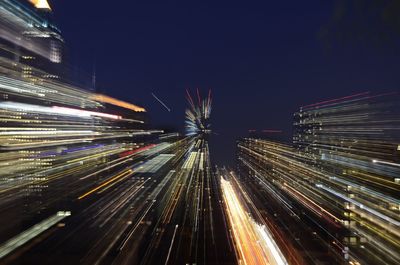 Illuminated city against sky at night