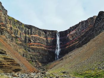 Low angle view of waterfall against sky