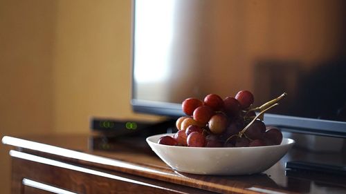 Close-up of fruits in bowl on table at home