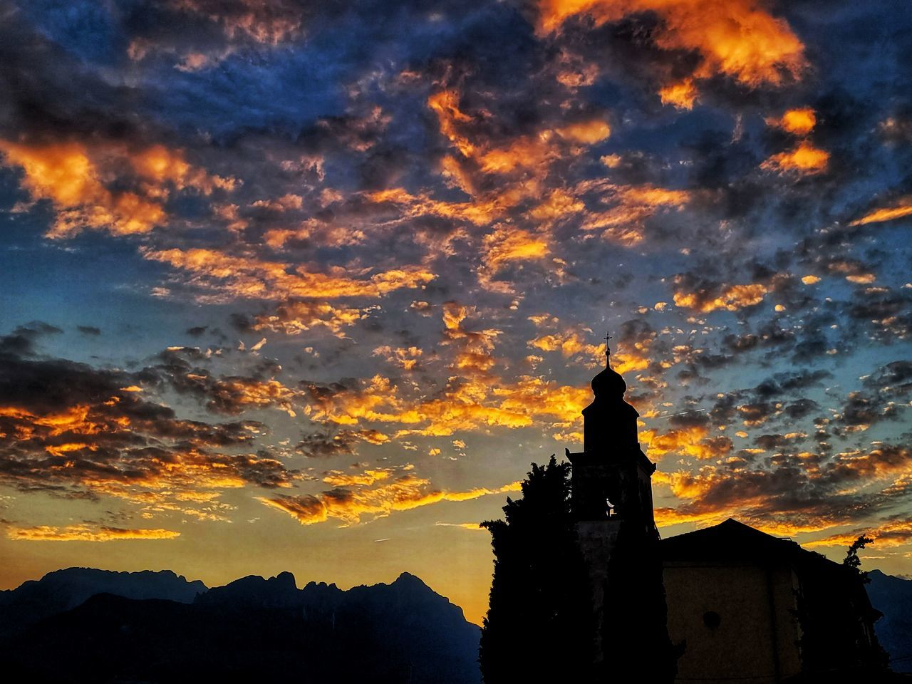 sky, architecture, cloud, sunset, dawn, built structure, evening, silhouette, building exterior, building, afterglow, nature, sunlight, religion, belief, place of worship, history, the past, beauty in nature, spirituality, travel destinations, scenics - nature, orange color, no people, temple - building, mountain, dramatic sky, outdoors, horizon, sun, red sky at morning, reflection