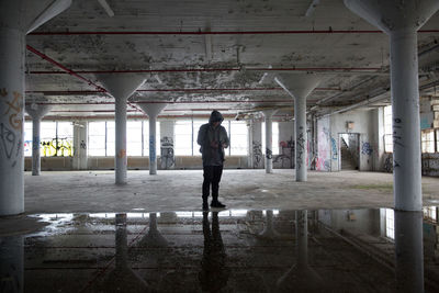 Man standing in corridor of building