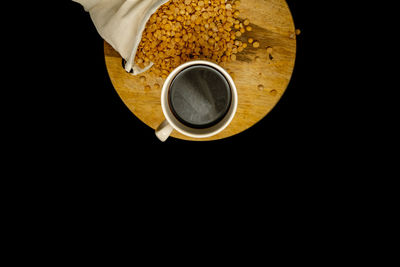 Directly above shot of coffee cup over black background