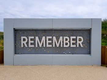 Information sign against blue sky