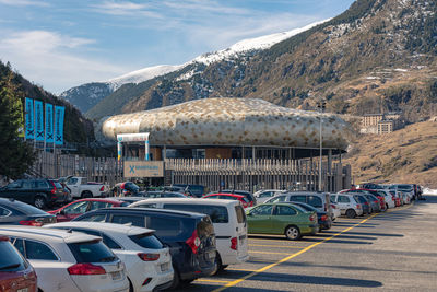 Vehicles on road against mountain range