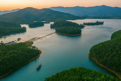 High angle view of river and mountains against sky
