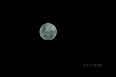 Low angle view of full moon against sky at night