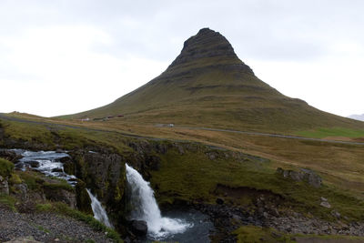 Scenic view of waterfall against sky