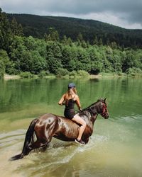 Man riding horse in lake