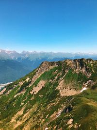 Scenic view of mountains against clear blue sky