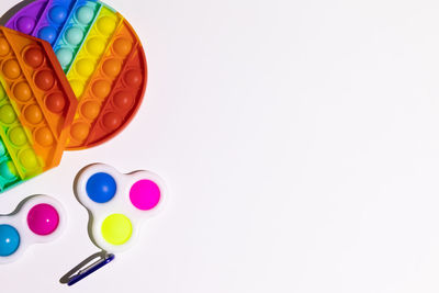 High angle view of multi colored pencils on white background