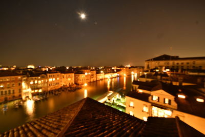 High angle view of buildings lit up at night