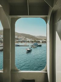 Boats sailing in sea against sky