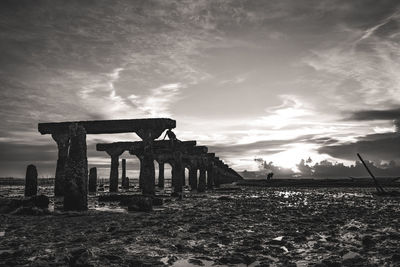 Old ruin on field against sky during sunset