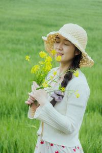 Young woman picking flowers