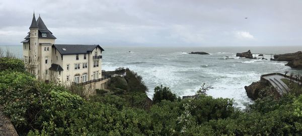 Panoramic view of sea and buildings against sky