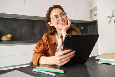 Young woman using laptop at office