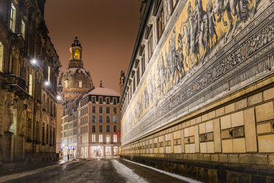 Street amidst illuminated buildings in city