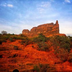 Rock formations on landscape against sky