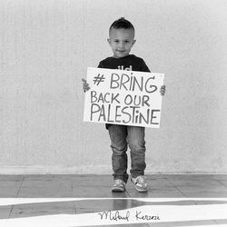 Full length of a boy standing against wall