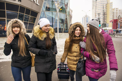 Portrait of smiling friends in city